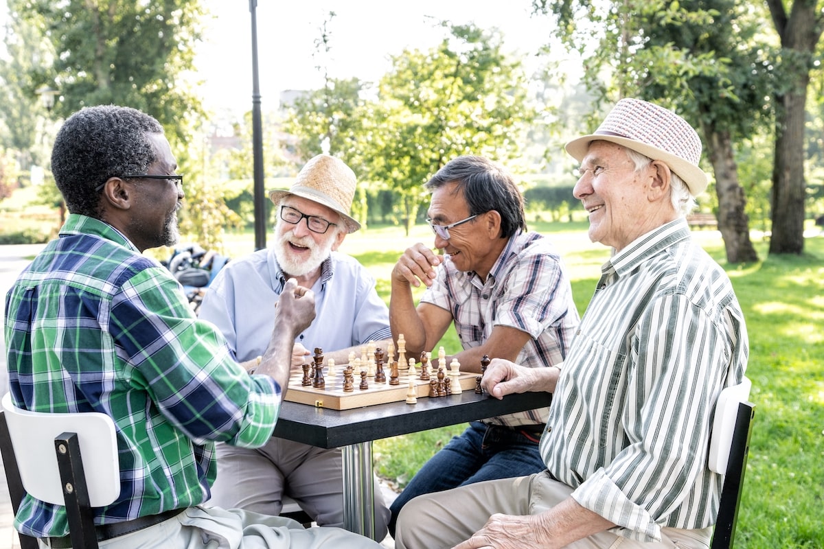 Group of older adults playing chess in an assisted living community