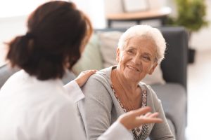 Caregiver talking to an older woman
